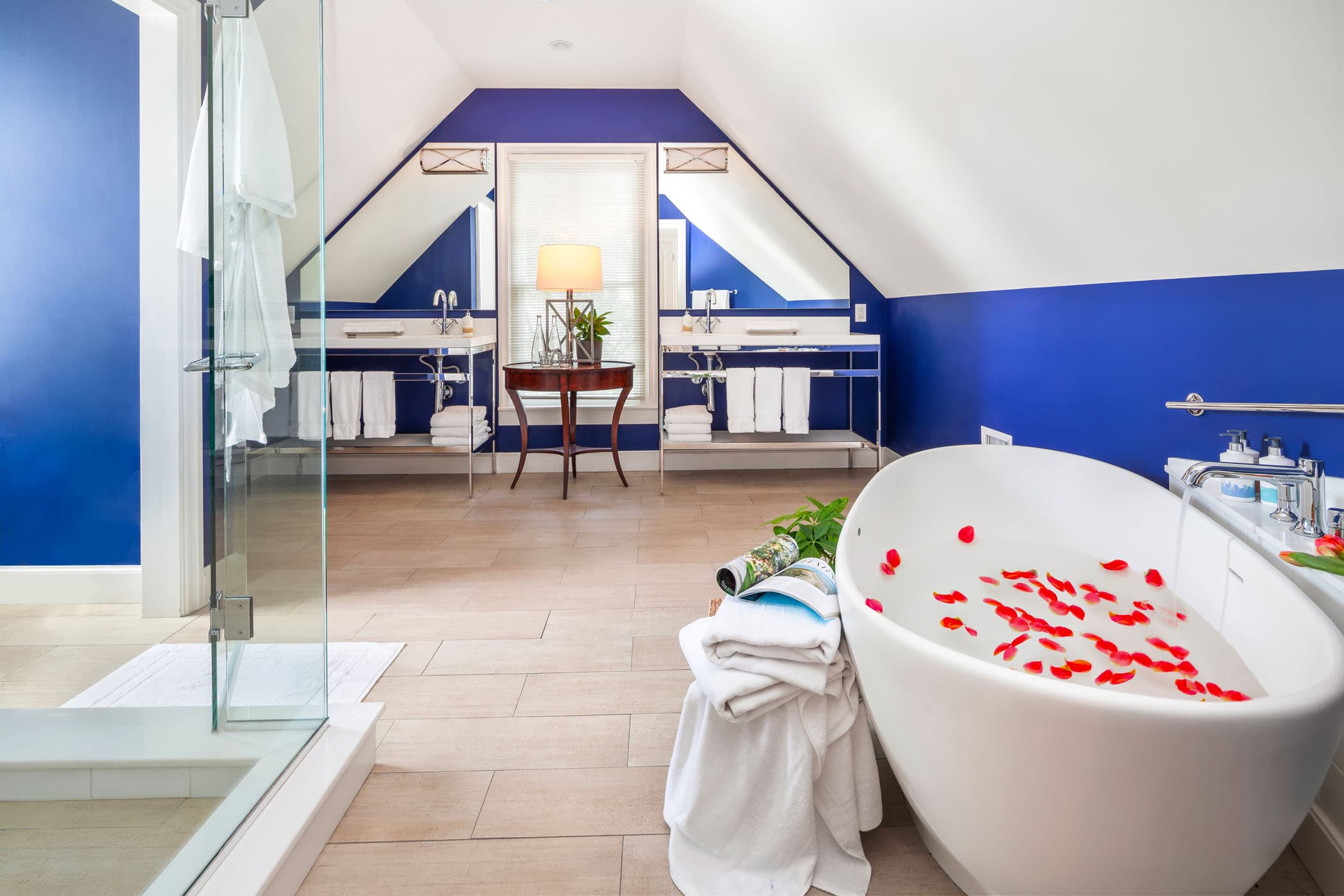 A bathroom at Marquesa with red petals in the soaker tub