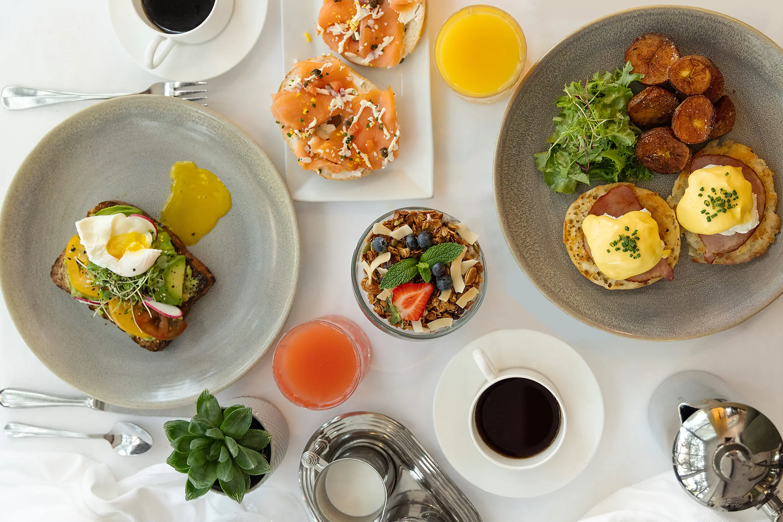 Eggs Benedict, avocado toast, and smoked salmon bagel brunch at Cafe Marquesa, The Marquesa Hotel Key West Florida.