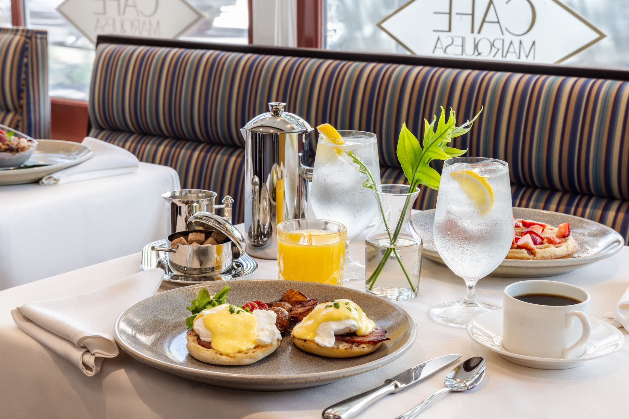 Eggs Benedict, waffles, coffee, and orange juice at Marquesa