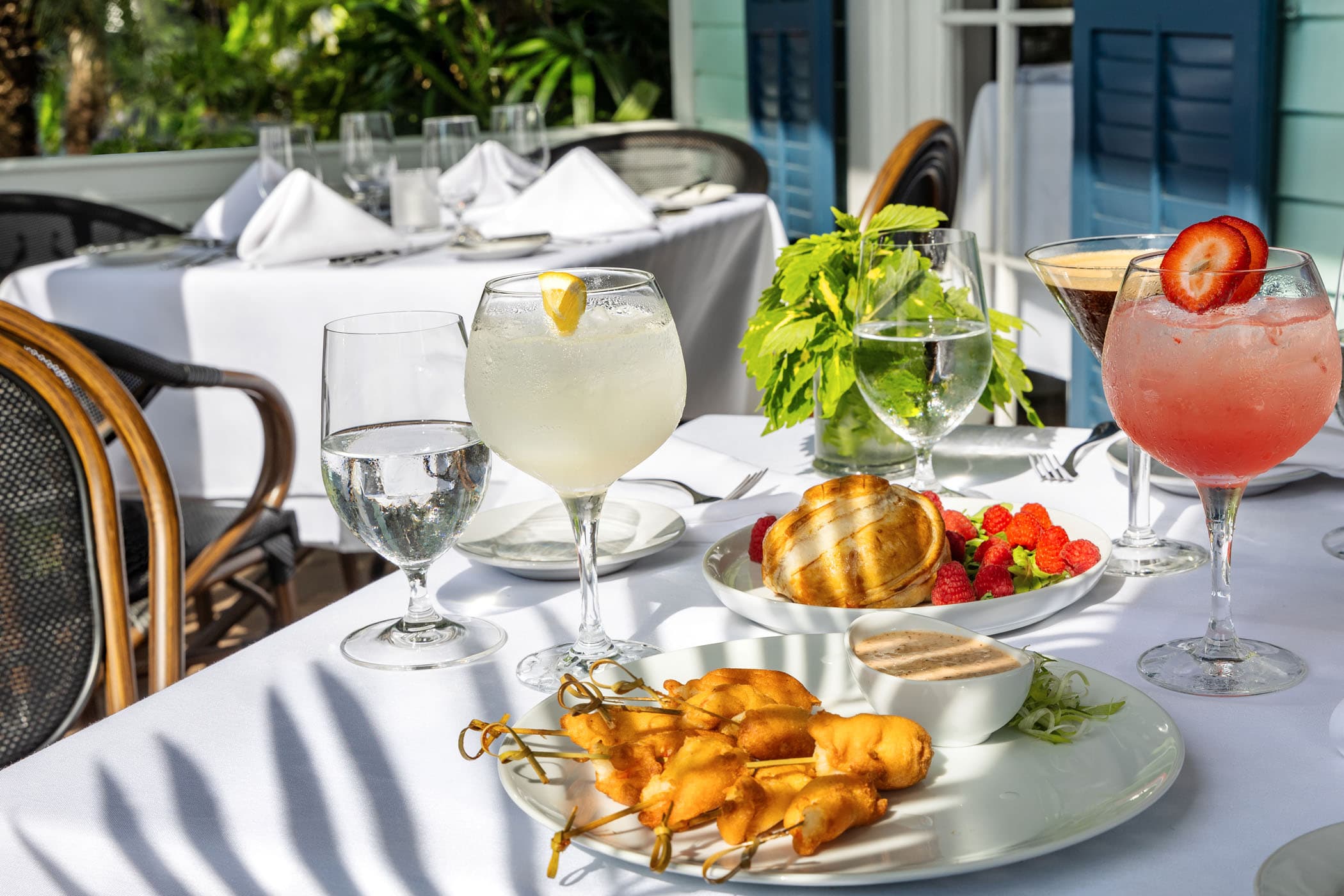 cocktails and food on a patio table at Marquesa