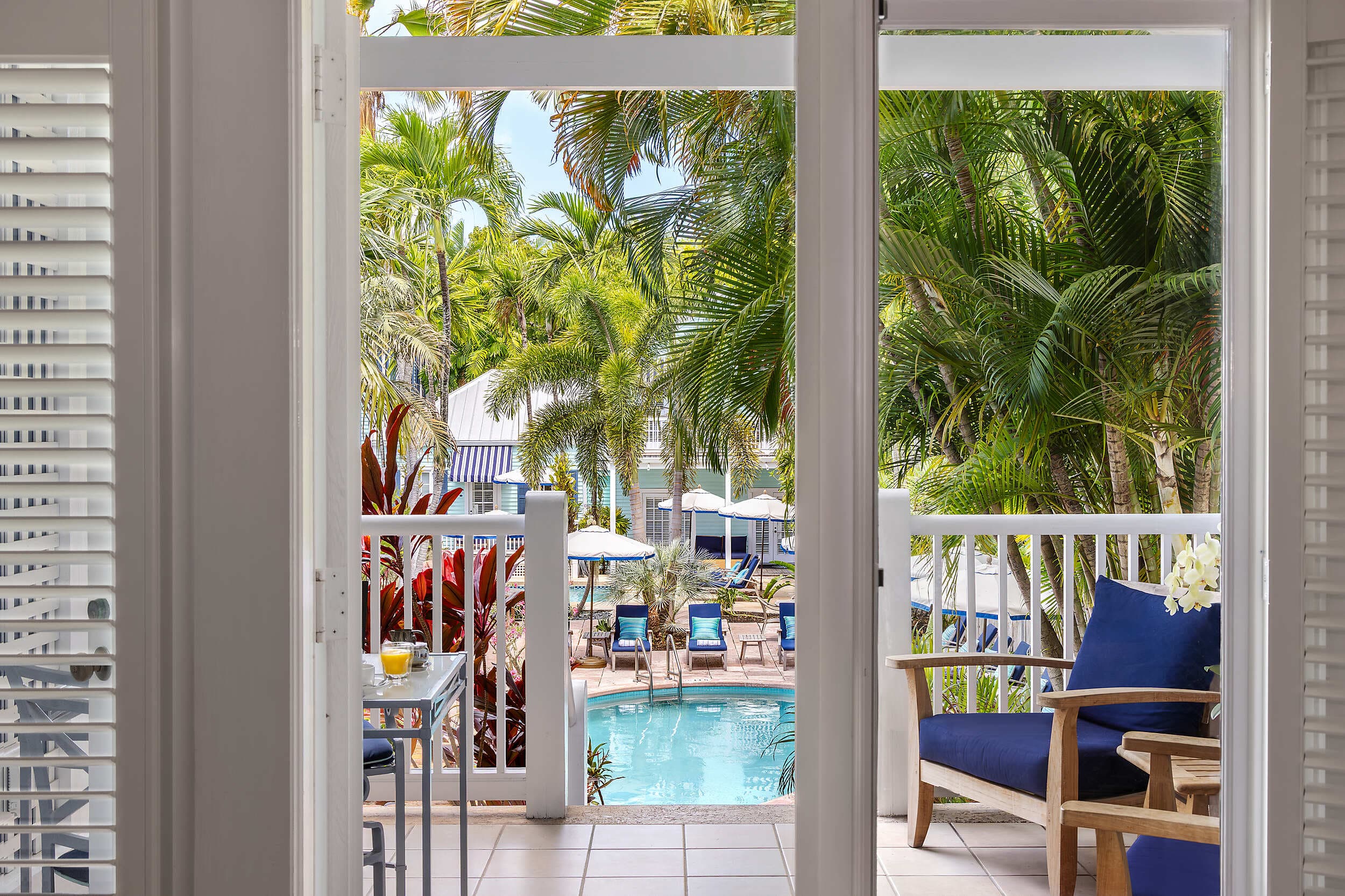 Private balcony view of the tropical pool and palms at the Marquesa Hotel Key West